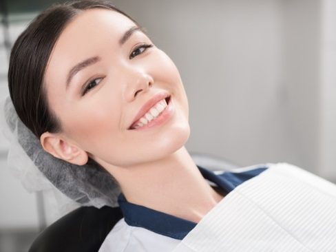 woman smiling in dental exam chair
