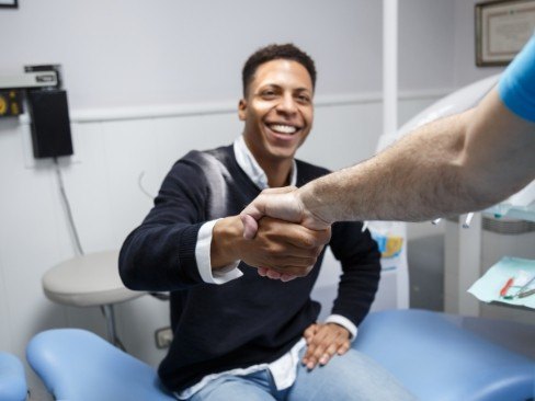 man shaking dentist's hand