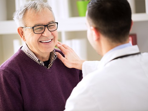 man smiling with dentist