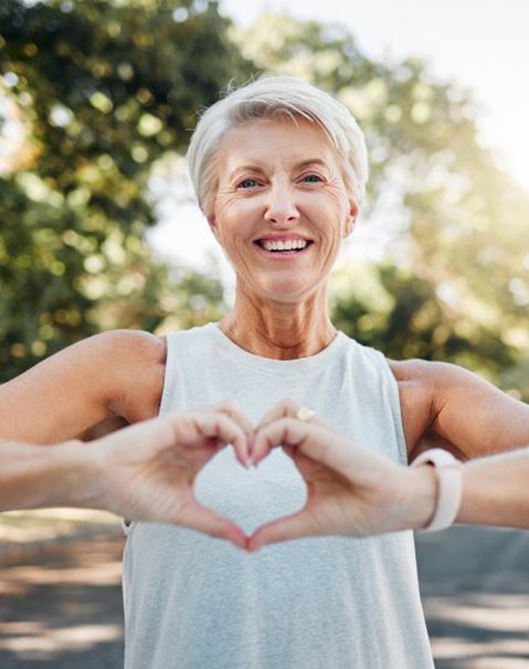 Lady makes shape of heart with her hands