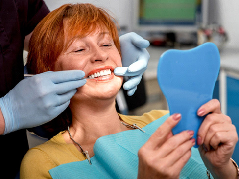 Woman smiling at dentist in Denver