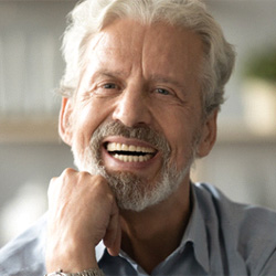 Man smiling with dentures in Denver