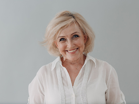 Woman smiling with dentures in Denver