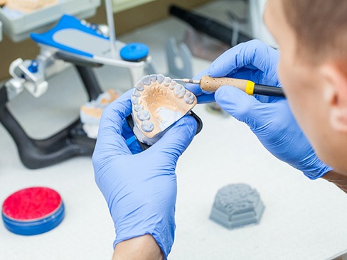 Technician carving dentures