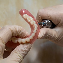 Technician filing dentures