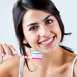 young woman brushing teeth