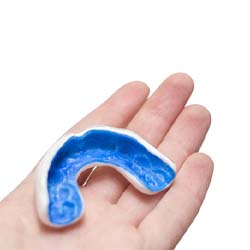 Person holding a mouthguard