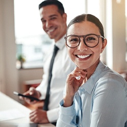 Woman with dental implants in Denver, CO smiling in office