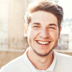 Man with dental implants in Denver, CO outside and smiling