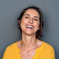 Woman smiling in yellow shirt