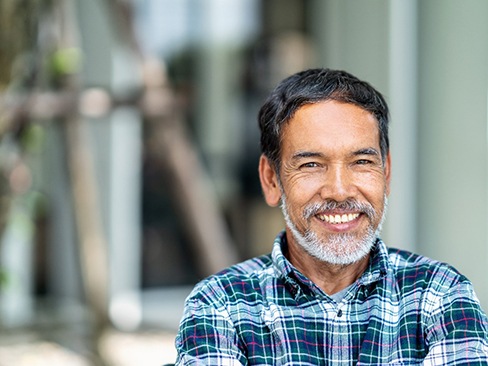 Man smiling with dental implants in Denver