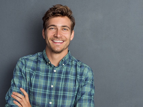 a man smiling after undergoing Invisalign in Denver