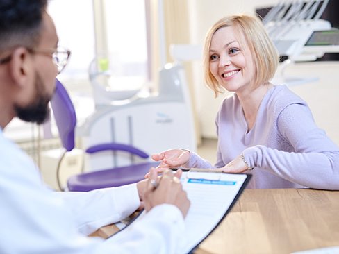 a woman discussing the cost of Invisalign in Denver