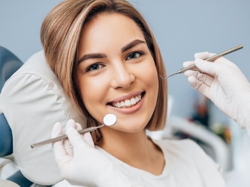 Woman smiling during dental checkup and teeth cleaning visit