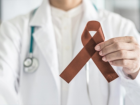 Dentist holding oral cancer awareness ribbon