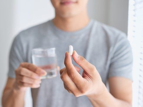 Man holding oral conscious dental sedation pill