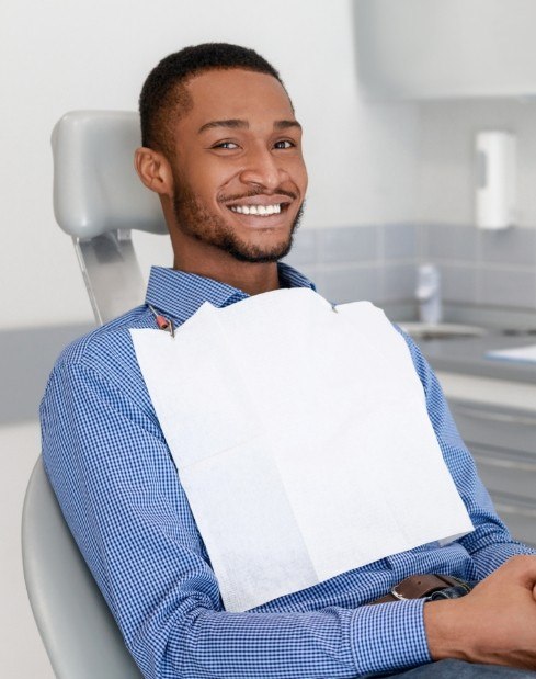 man smiling in dental exam chair