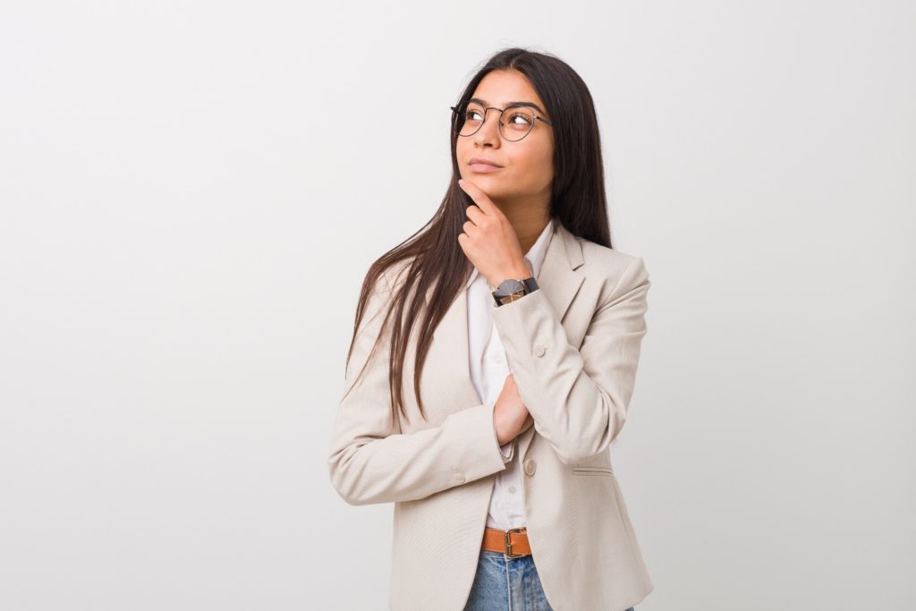 Closeup of woman in tan blazer wondering