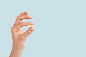 Picture of someone holding a pill