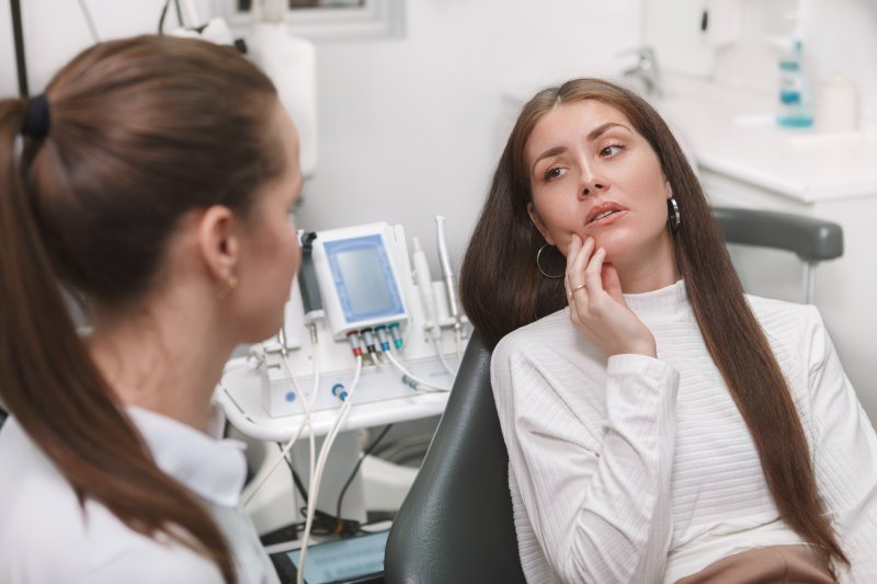 A woman with a toothache visiting her dentist