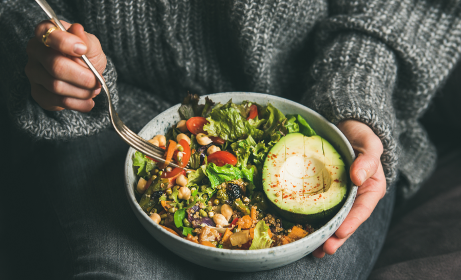 Woman eating veggie bowl